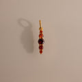 The Ombre Lace Garnet Charm is a gold pendant with red and purple gemstones set vertically—an elegant, personalized charm and perfect gift for a birth month.