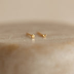 The Tiny Moon & Star Studs in 18K Gold, featuring one star and one crescent moon design, add a celestial touch that's perfect for constellation-themed jewelry lovers.