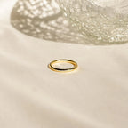 The Agate Diamond Rings Set, inspired by vintage designs, is displayed on soft light fabric next to a textured glass object.