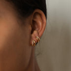 Side view of Amelia Duo Huggies stacked on a model’s ear, showing their dual-band design.