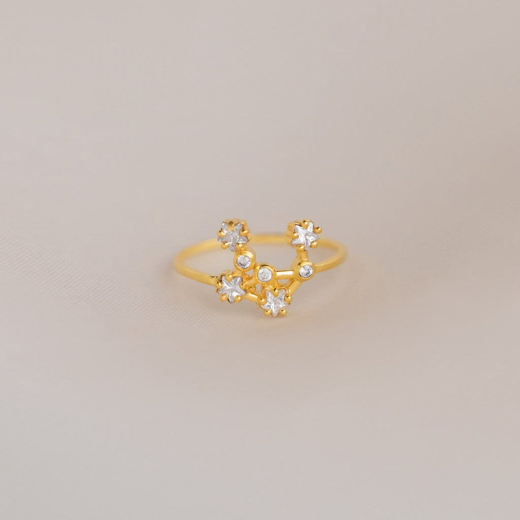 The Constellation Ring features a gold band adorned with sparkling diamonds, embodying the elegance of celestial-inspired jewelry.