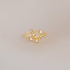 The Constellation Ring features a gold band adorned with sparkling diamonds, embodying the elegance of celestial-inspired jewelry.