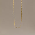 The Men's Snake Chain Necklace hangs against a plain, neutral background, showcasing minimalist elegance and timeless style—an ideal choice for men’s jewelry.