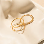 The Diamond Stacking Ring Set in 18K Gold features three unique gold rings displayed on ivory satin—an elegant and thoughtful Christmas gift.