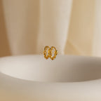 The Link Huggies float elegantly in the air, making them the perfect addition to your stylish earring stack.