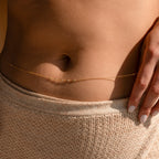 Close-up of a woman's bare midriff styled with Beaded Belly Chains and beige knit pants, capturing an effortless boho-chic vibe.