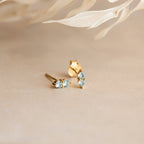 The Duo Birthstone Studs feature blue stones, making them a perfect bridesmaids gift or a personalized addition to your style.