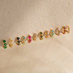 The Triple Ruby Huggies feature three sparkling rubies set in gold—perfect for lovers of minimalist jewelry.