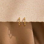 Diamond Link Hoops displayed on a textured beige surface with soft shadows—perfect as elegant wedding earrings or a chic bridal accent.