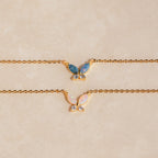 The Pink Opal Butterfly Necklace features a gold chain and a delicate butterfly pendant, adding a whimsical touch to any look. Perfect for layering with your favorite gemstone charm necklaces.