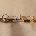 The Crescent Moon Opal Huggies are gold and silver hoop earrings perfect for stacking or wearing solo.