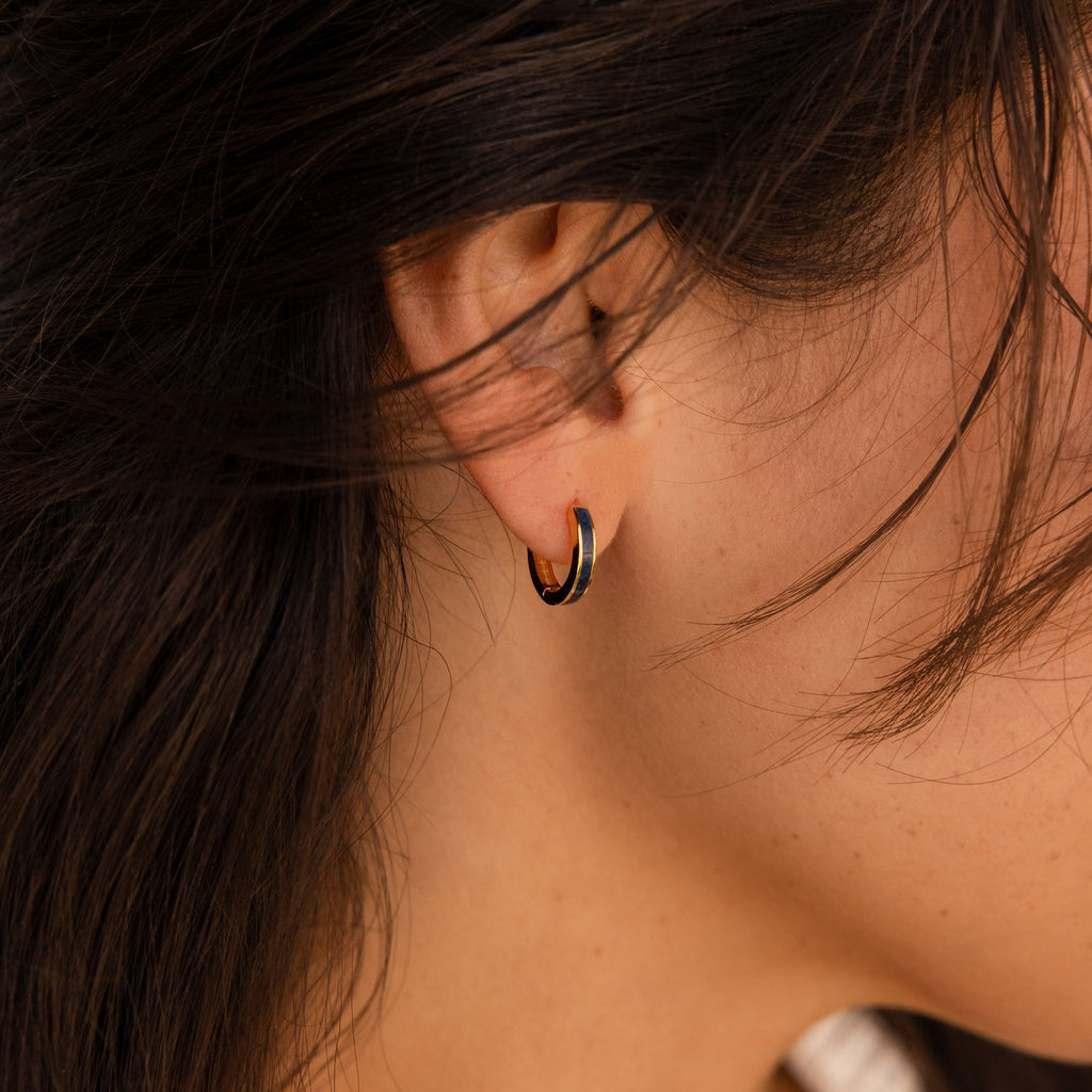 Close-up of a woman’s ear wearing Opal Inlay Hoops Set—delicate gold hoops ideal for bridal jewelry or wedding earrings—her dark hair softly framing her face.