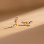 Tiny Diamond Climbers featuring three sparkling diamonds in each earring, displayed on a softly lit neutral surface—an ideal anniversary gift.