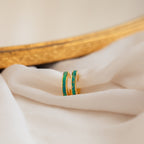 The Opal Inlay Hoops Set, ideal for bridal jewelry, is displayed on soft white fabric with a gold frame in the background.