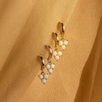 Two pairs of Opal Cluster Huggies in gold and silver, with clustered opal beads on a beige fabric background—perfect dainty hoop earrings for a unique bridesmaid gift.