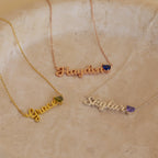 Three Mellow Name Heart Birthstone Necklaces labeled Grace, Hayden, and Skylar, each with a delicate birthstone gem, displayed on a marble surface.