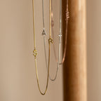 Gold and silver Duo Initial Necklace in Box Chain featuring S, A, and R letter charms, elegantly displayed on a neutral background. Personalize your style with this perfect accessory.