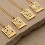 Four gold Calendar Birthstone Necklaces on chains, each personalized with a name and date marked by a birthstone gem—unique keepsake jewelry for any occasion.