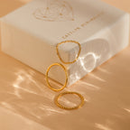 The Textured Stacking Ring Set features three minimalist rings showcased on and beside a white jewelry box with a heart design—ideal for lovers of simple, elegant style.
