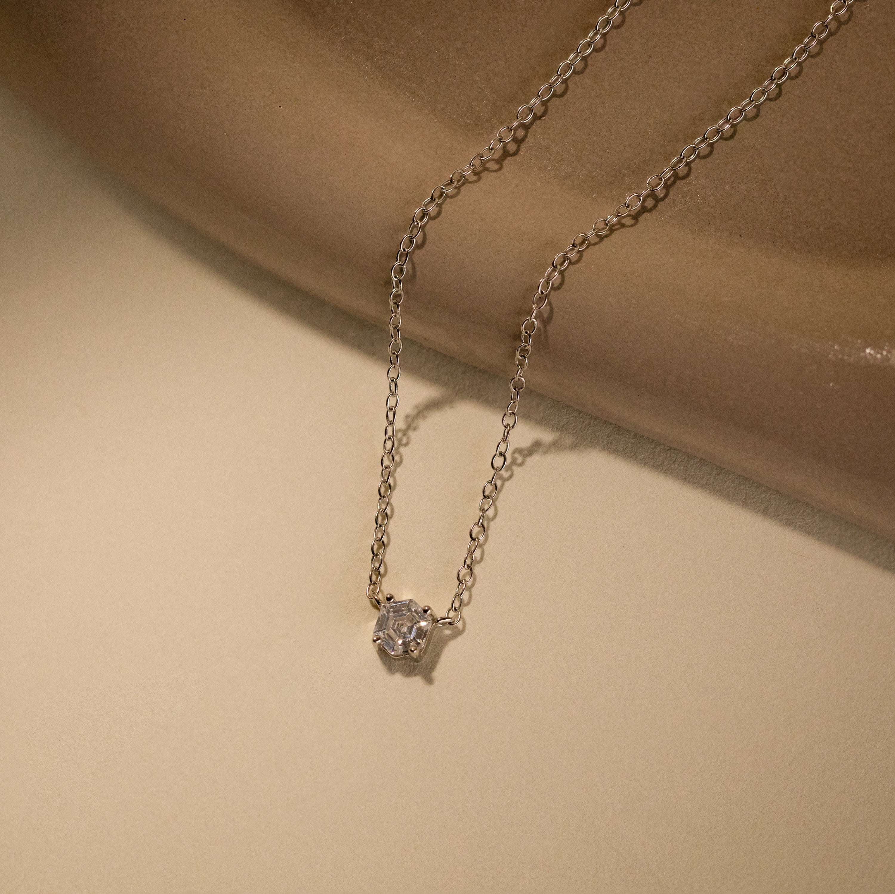 The Hexagon Diamond Necklace features a striking geometric design with a rose-cut diamond pendant, blending modern style with classic elegance.