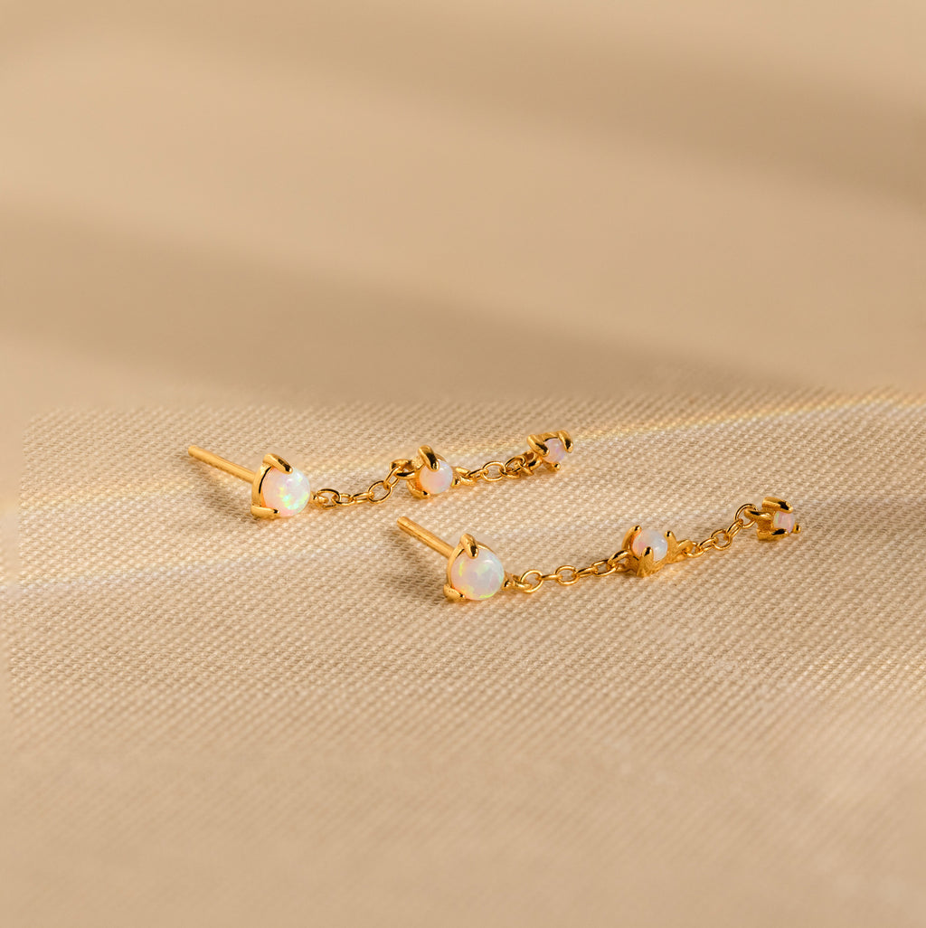 Opal Chain Drop Earrings feature gold and white stones—ideal for elegant bridesmaid jewelry or adding a subtle statement to any outfit.