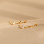 Opal Chain Drop Earrings feature gold and white stones—ideal for elegant bridesmaid jewelry or adding a subtle statement to any outfit.