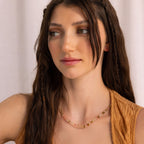 Brunette woman with braided hair wearing a sleeveless tan top and a Rose Quartz Beaded Necklace—an ideal gift for your best friend.