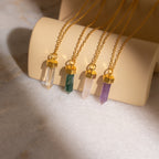 Four Rose Quartz Necklaces—the timeless stone of love—are displayed in different colors on a beige holder.
