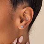 A close-up of a woman’s ear wearing Moonstone Star Studs, showcasing her love for celestial-inspired jewelry.