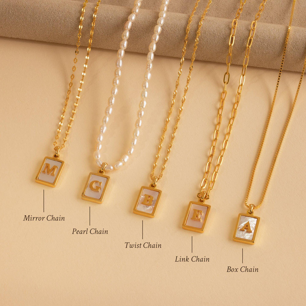 The Pearl Initial Tag Necklace, with customizable chain options like pearl, mirror, twist, link, and box styles, makes a perfect personalized Christmas gift.