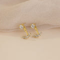 Round Diamond Ear Jackets in 18K Gold are displayed on a beige textured fabric background, highlighting the refined elegance and sparkle of these stylish earrings.