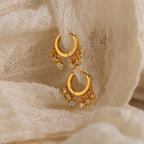 Chandelier Diamond Huggies showcased on textured cream-colored fabric.