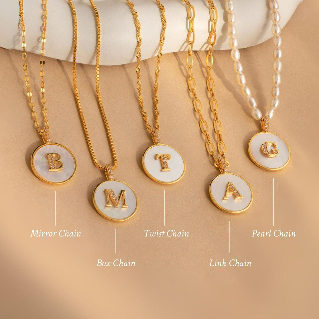 Five Gemstone Initial Disc Necklaces, each with a different chain—Mirror, Box, Twist, Link, and Pearl—make a stunning personalized set for any style. Perfect for those who love custom gemstone jewelry.