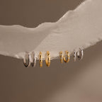 Classic Diamond Sprinkle Huggies pair beautifully with gold and silver rings, creating a timeless accessory collection.