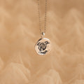 The Pet Portrait Coin Necklace is a silver custom piece featuring a round pendant engraved with a dog’s face and the name Cooper, perfect as pet memorial jewelry.