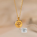 The Paw Print Coin Necklace features a round pendant engraved with a paw print—perfect as customizable pet jewelry or a pet memorial necklace.