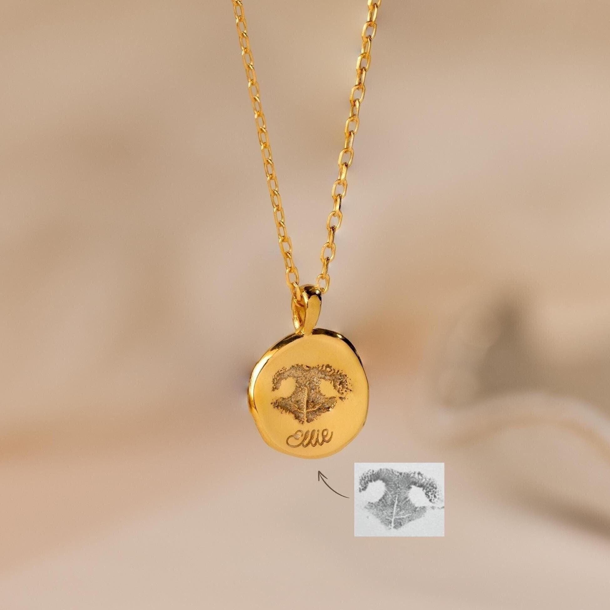 The Paw Print Coin Necklace features a round pendant engraved with a paw print—perfect as customizable pet jewelry or a pet memorial necklace.