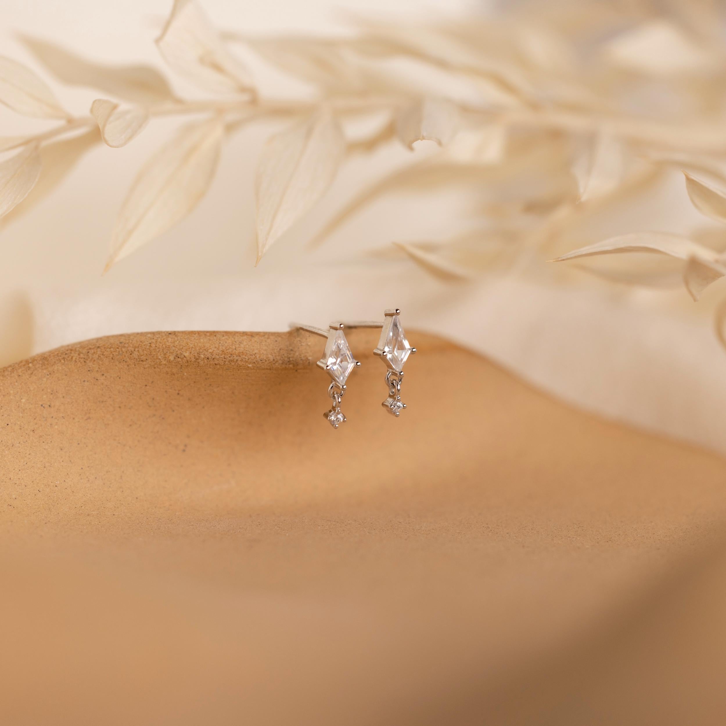 Diamond Kite Drop Earrings add vintage charm and elegance to tan skin.