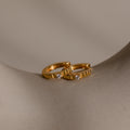 Two Diamond Ribbed Huggies, featuring a ribbed texture and small diamonds, are shown on a smooth beige curved surface.