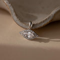 Silver Pave Evil Eye Charm. The design features a marquise diamond in the center with pave gemstones surrounding it in the shape of an eye.