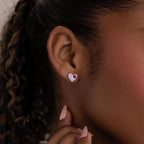 Close-up of a woman's ear wearing Mixed Birthstone Heart Studs, elegant earrings with silver and pink accents and customizable birthstones.