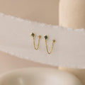 Agate Diamond Chain Earrings featuring green stones and delicate chains, displayed on a textured white fabric background.