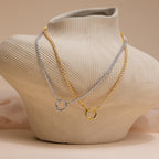 The Diamond Tennis Clasp Necklace in White Gold, ideal for weddings, is displayed on a textured beige jewelry bust.