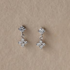 Ivy Flower Flat Back Studs in Sterling Silver, featuring round and flower-shaped diamond clusters on a beige background—an elegant Mother’s Day gift sure to impress.
