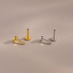 A set of four Flat Back Posts — two gold and two silver — arranged upright and angled on a neutral-toned background.