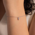 Delicate silver chain bracelet with a small crystal cross charm, minimalist and elegant jewelry piece that adds a subtle sparkle and meaningful touch to everyday style.