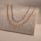 The Eternity Pearl Choker Necklace displayed on a textured beige stand, perfect for showcasing timeless beauty and ideal as elegant wedding jewelry.