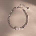 Beaded Pearl Bracelet in silver featuring faceted metallic beads with a single natural white pearl centerpiece, displayed on a neutral background for a sleek, modern look.
