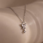 The Butterfly Drop Necklace in Sterling Silver features a delicate, sparkling pendant inspired by nature, elegantly resting on smooth, light-colored skin.