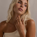 Model wearing stacked gold and silver curve rings with marquise cut stones, styled on her finger for a modern, elegant look.